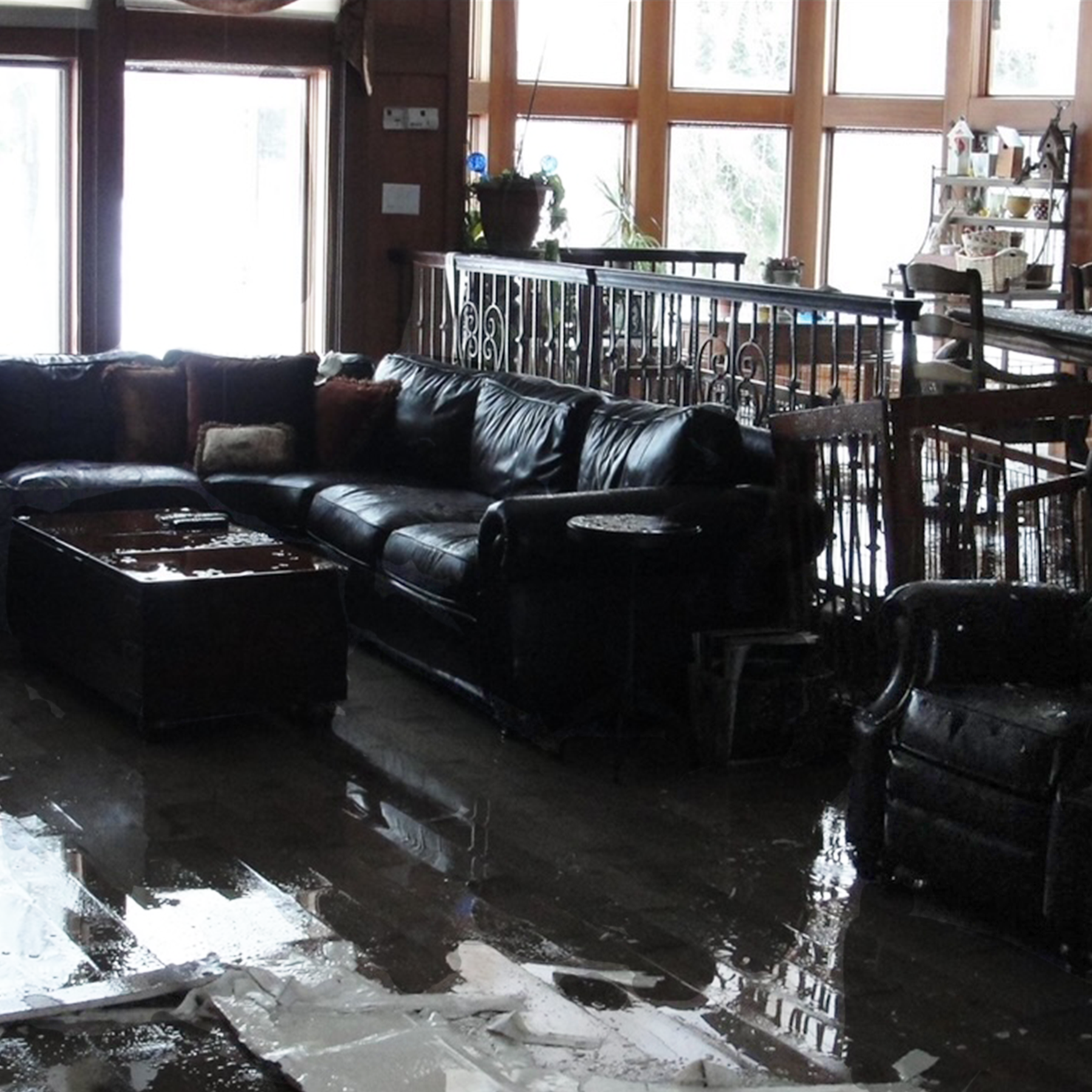 Flooded living room with water-damaged furniture