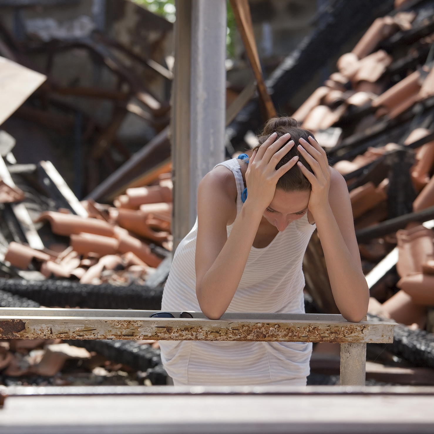 Homeowner standing in front of a fire-damaged home