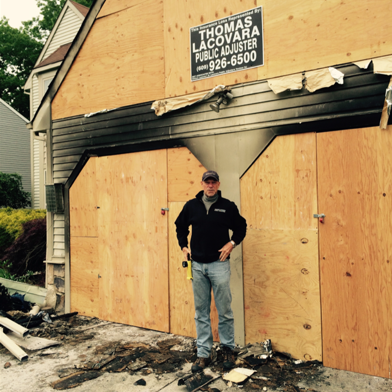 Thomas Lacovara Public Adjuster job-site sign at a fire-damaged home